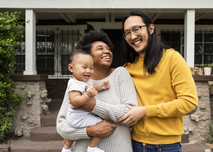 happy-multiethnic-family-standing-front-house-during-covid19-lockdown-scaled.jpg